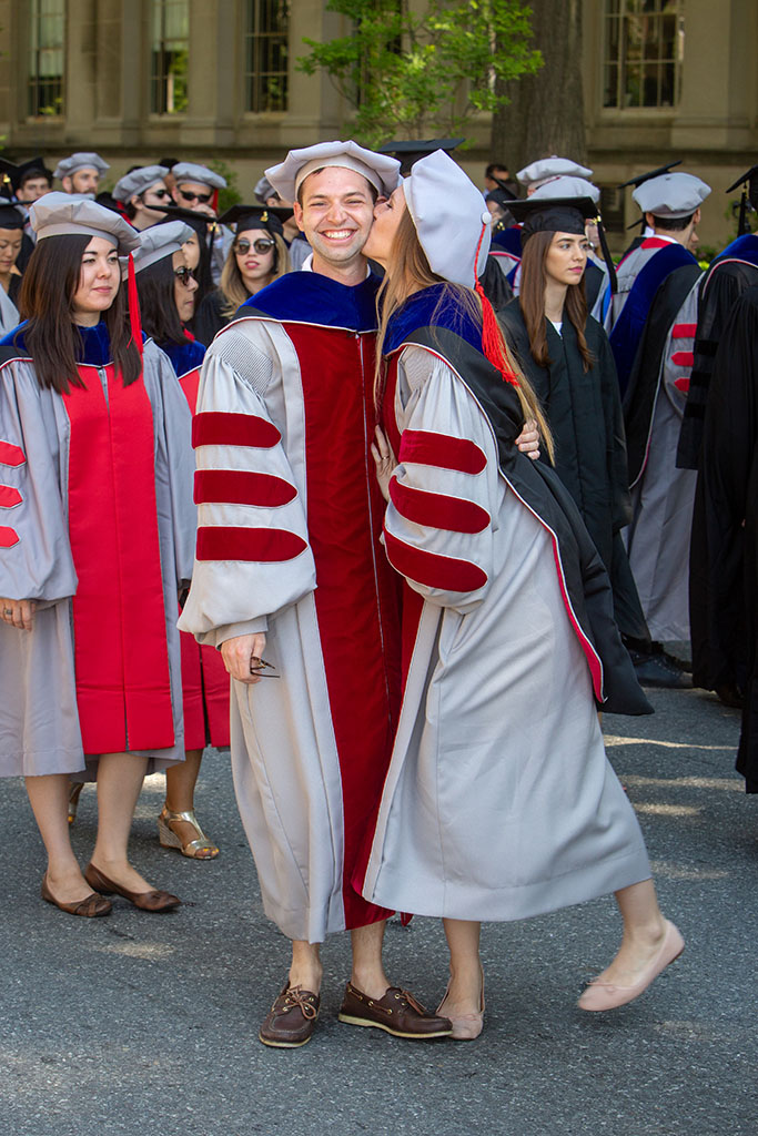 Scott Nill and Larissa Nietner kiss at graduation