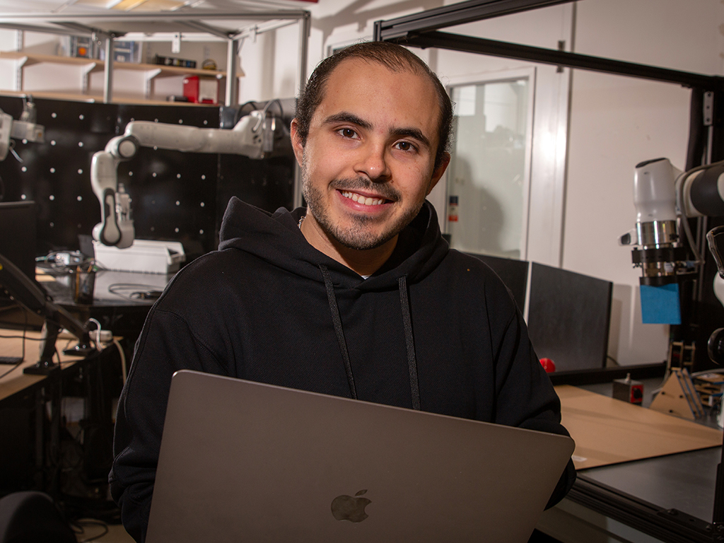 Bernardo Cabezas in the lab with laptop